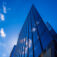 Abstract architecture background with blue sky and modern office building with reflection in the window glass