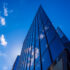 Abstract architecture background with blue sky and modern office building with reflection in the window glass