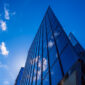 Abstract architecture background with blue sky and modern office building with reflection in the window glass